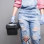 woman-overall-holding-tool-box